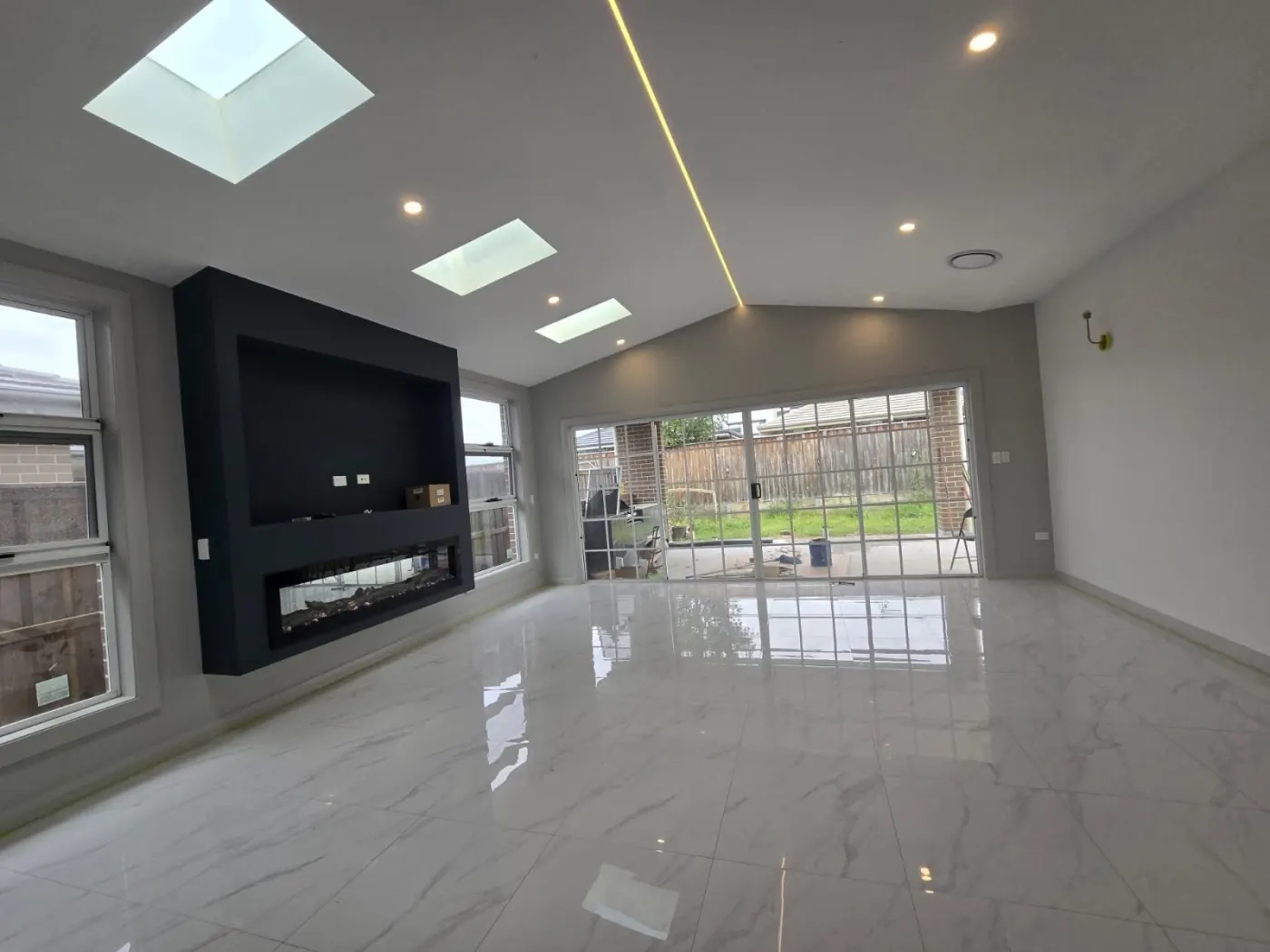 Living room with skylights and fireplace
